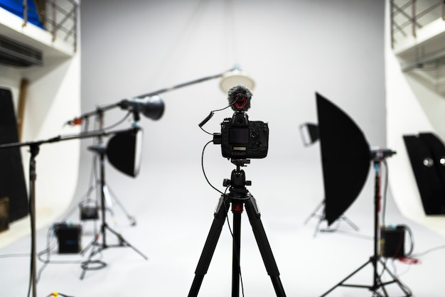 Professional video production studio setup with camera on tripod, microphone and softbox lighting