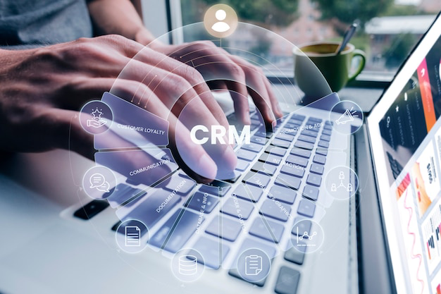 Person typing on laptop with CRM icons for customer loyalty, communication and documentation representing Revup365 CRM
