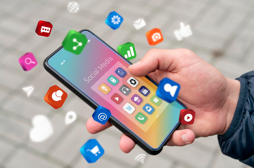 Hand holding smartphone with social media apps and floating icons for sharing, messaging and engagement